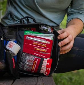person holding open first aid kit