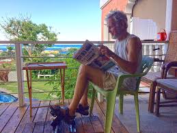 K-Tor Power Box 50- man outside sitting in lawn chair pedaling generator while reading a newspaper